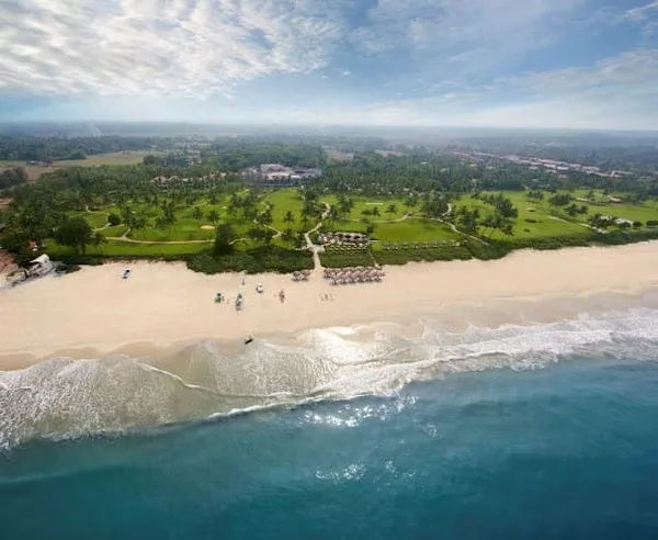 A private beach resort, captured from a drone flying over water.