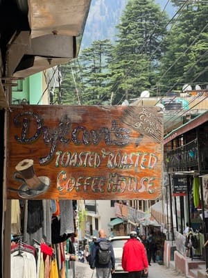 wall painted with a lady enjoying coffee at dylons coffee in manali