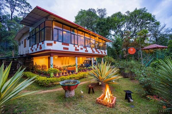 Hostel exterior surrounded by greens
